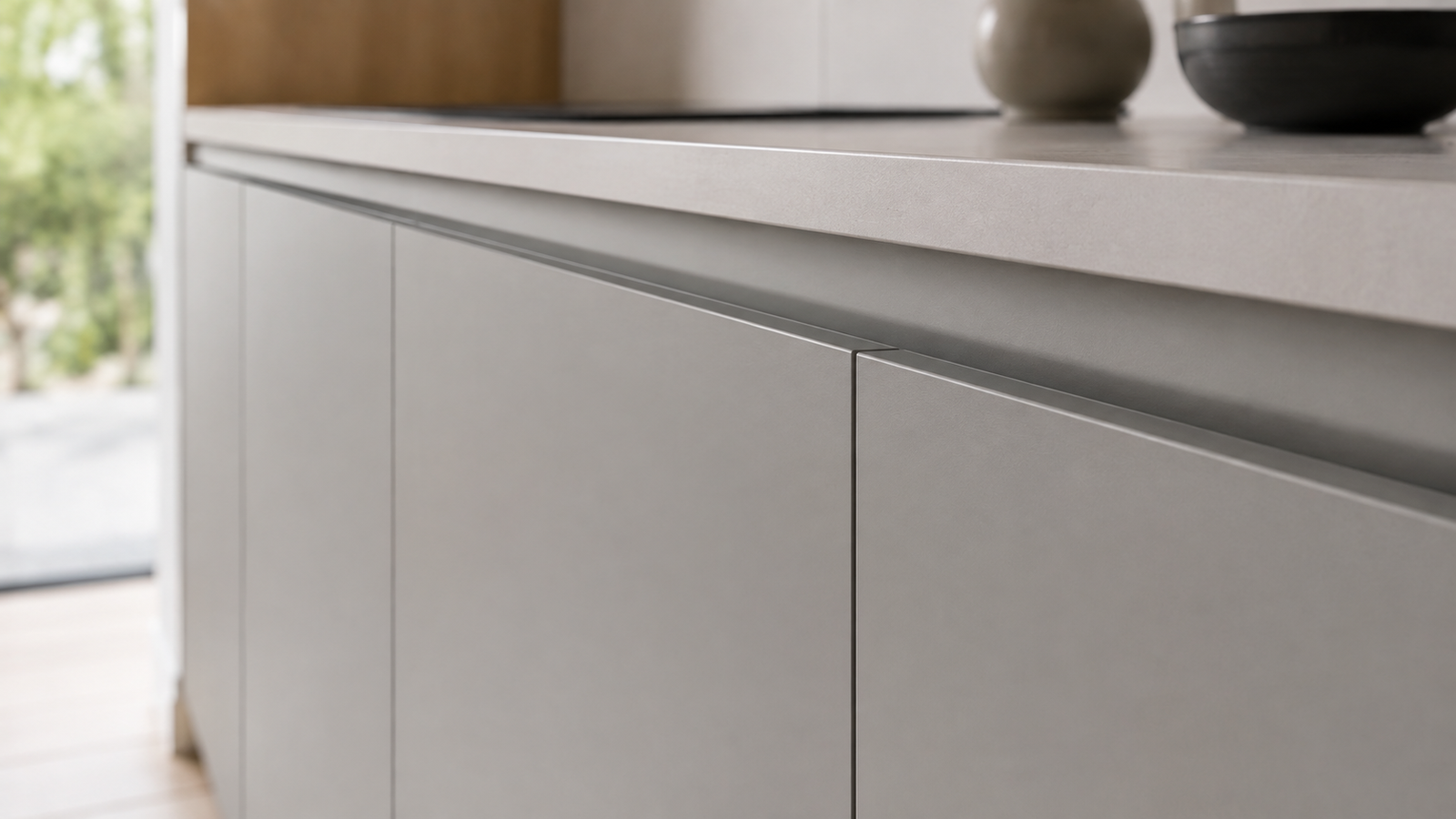 Detalle de perfil gola integrado en gabinete de cocina sin manijas visibles